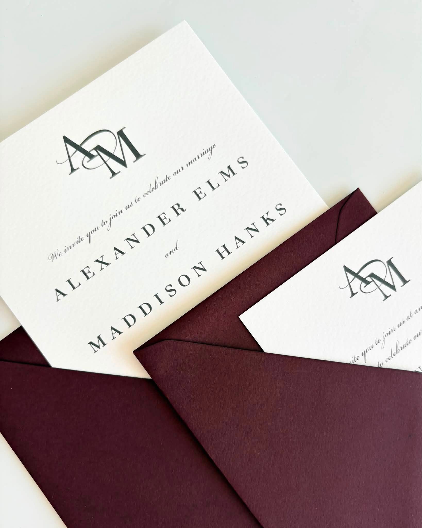 Monochrome wedding invitation with burgundy envelopes