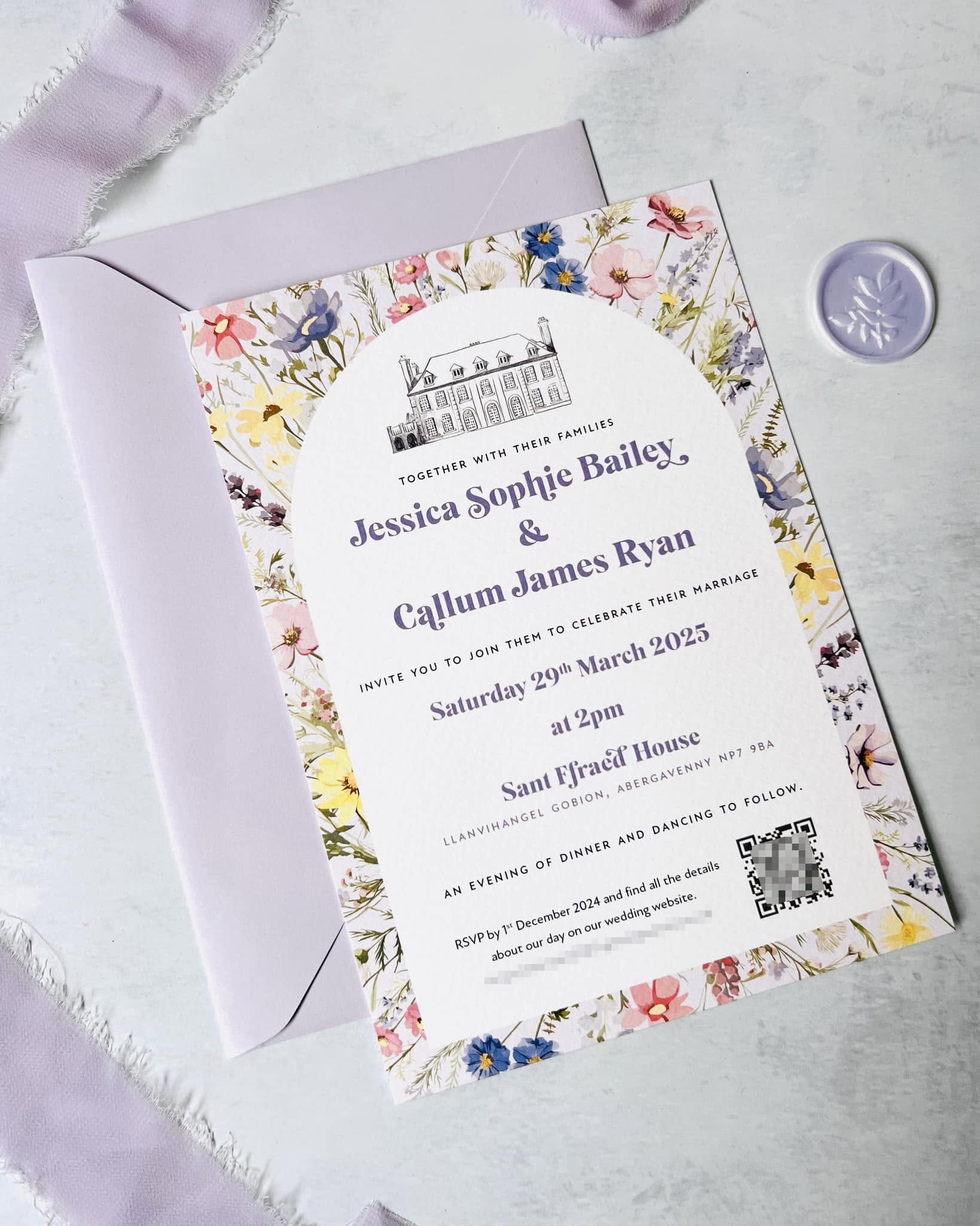 Pastel wildflower wedding invitation with venue illustration